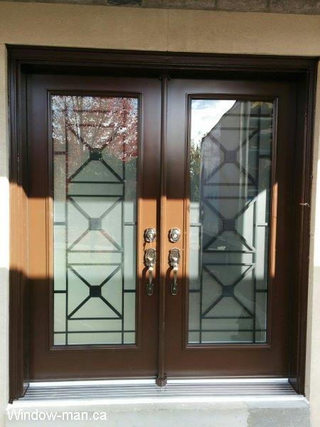 Double front entry steel insulated exterior doors. Brown. Century contemporary wrought iron glass door inserts